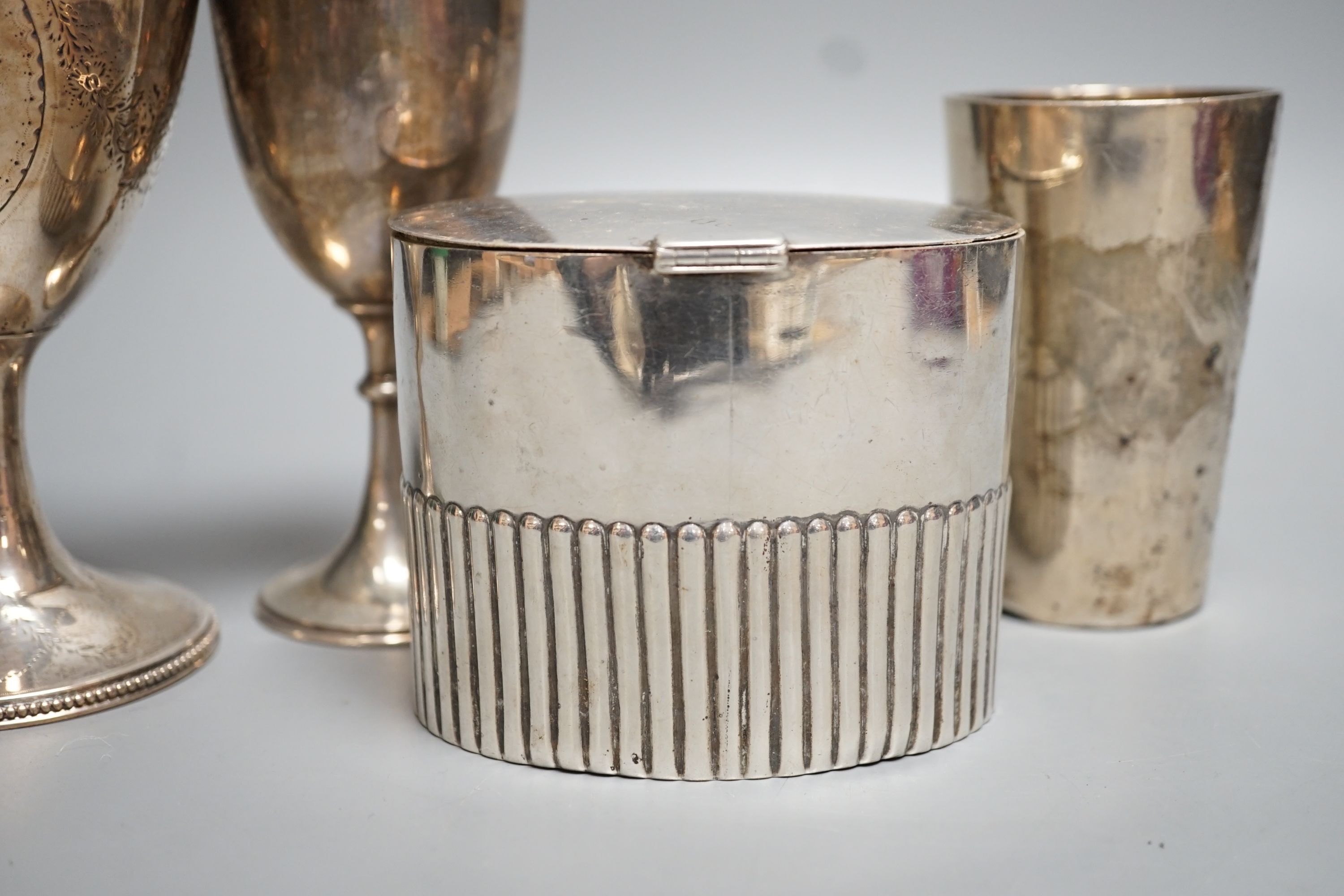 A George III engraved silver goblet, maker's mark rubbed, London, 1784, 14.6cm, together with an Edwardian silver tea caddy, a Victorian goblet, silver beaker and Brittania standard two-handle bowl by George Perkins, Lon